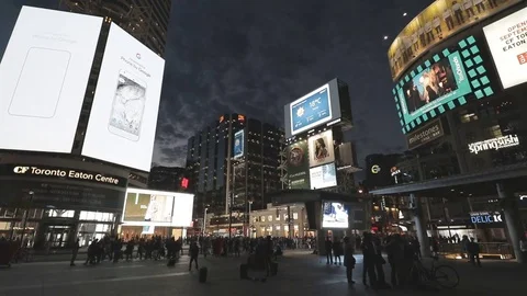 Busy Downtown Intersection at night with lots of TV Signage Stock Footage 70605674