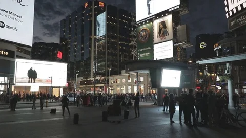 Busy Downtown Intersection at night with lots of TV Signage Stock Footage 70605874
