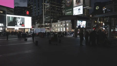 Busy downtown intersection at night with TVs and signage. Stock Footage 70604037