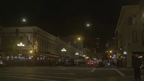 Busy Downtown Intersection with Traffic and Pedestrians at Night 스톡 동영상 343940803