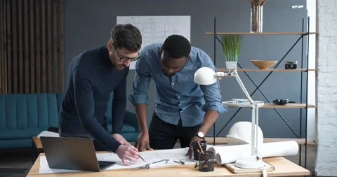 In Busy Engineering Bureau Two young Engineers Discussing Technical Issues over Stock Footage 155640872