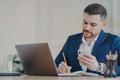 Busy executive manager organizing notes by writing them down with pencil Stock Photos