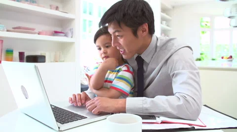 Busy Father Working From Home With Son Stock Footage