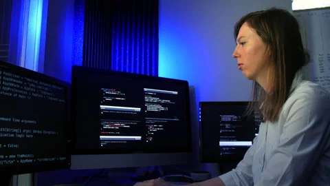 A busy female computer programmer programming artificial intelligence code Stock Footage 254051532