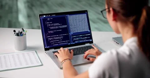Busy Female Programmer Balancing Code And Time At Work Desk. Stock Photos