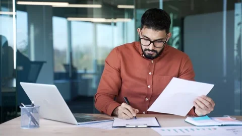 Busy financiers doing paperwork computer while sitting at desk at workplace  Stock Footage 305655628