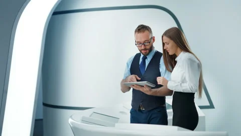 Busy friendly workers with tablet pc talking and planning future work in hi-tech Video stock 92276645