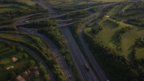 Busy Highway Interchange and Golf Course From Above at Golden Hour Stock Footage 334948027