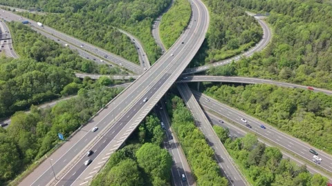 Busy Highway Interchange With Multiple Road Levels and Green Trees Stock Footage 336953707