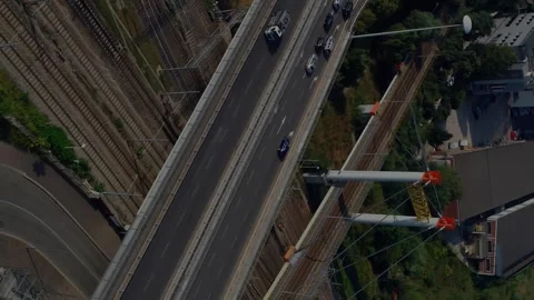 Busy highway intersecting railway tracks in urban area, animation of city Stock Footage 313425859