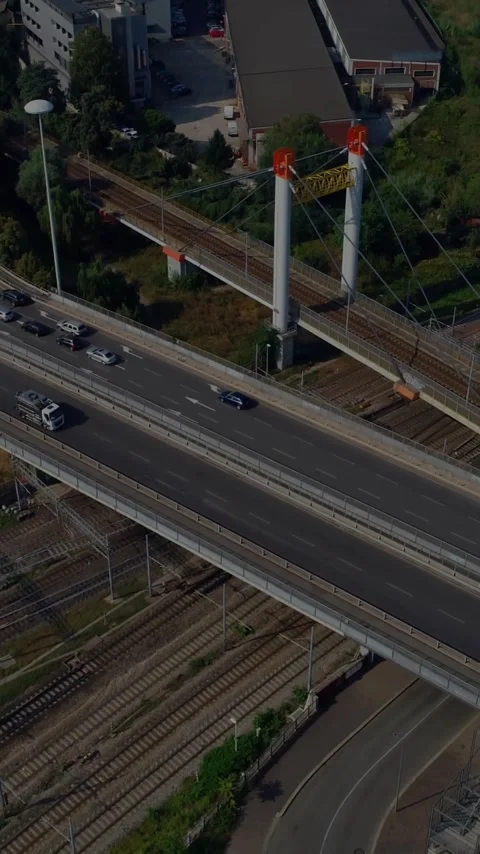 Busy highway intersecting railway tracks in urban area, animation of city Stock Footage 319618125