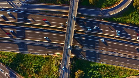Busy highway intersection with multiple roads and vehicles during daytime in an Stock Footage 336503342
