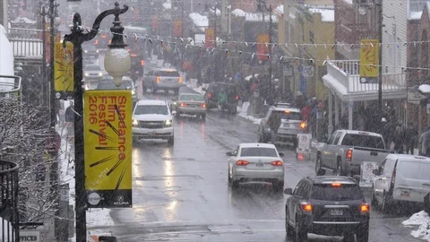 Busy historic Main Street while snowing during the Sundance Film Festival. Stock Footage 98007382