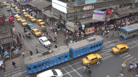 Busy intersection, MG Road, tram, streetcar, traffic in Kolkata, India Stock Footage