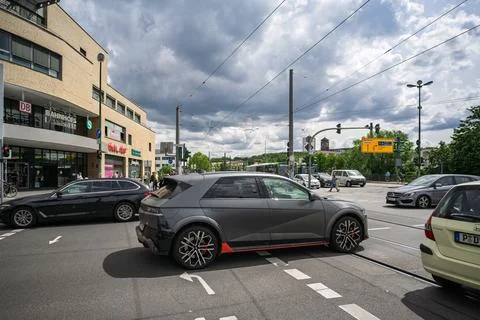 Busy intersection near main train station with cars and traffic lights. Stock Photos