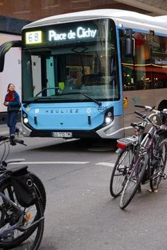 Busy intersection with a public bus and parked bicycles in the heart of a c.. Stock Photos