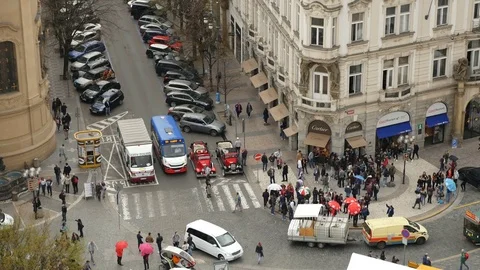 The busy intersection with several cars and tourists in Prague in autumn Stock-Footage 76016973
