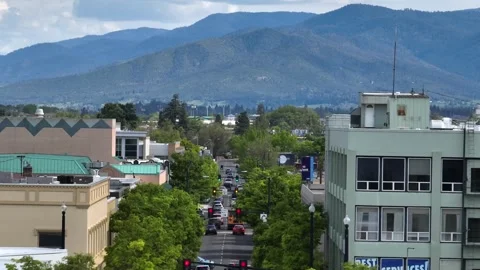 Busy intersection winds through Medford rooftops and storefronts, traffic Video stock 338414961