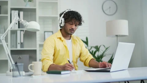 Busy IT specialist programmer wearing headphones working typing coding on laptop Stock Footage 235482645