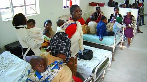 Busy Kenyan African hospital waiting area with patients and families. Stock Footage