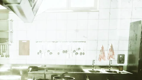 Busy kitchen with cooking pots and clean utensils in a restaurant setting Stock Footage 343506988