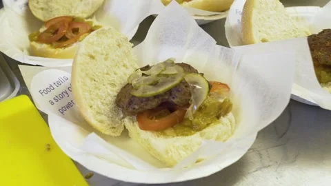 Busy kitchen preparing their own signature burgers Stock Footage 229579042