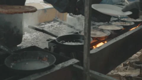 Busy Kitchen with Sizzling Pans and Cooking Process Stock Footage 335588442