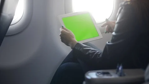 Busy lady using tablet in comfort airplane Stock Footage 103948626