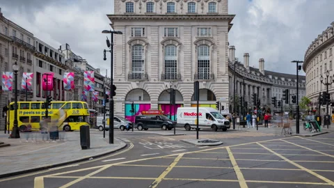 Busy London Intersection with Iconic Red Buses and Historic Architecture Stock Footage 334243735