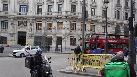 Busy Madrid intersection with historic buildings and passing vehicles Stock Footage 334504751