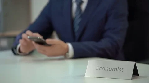 Busy male economist typing message and scrolling websites on modern smartphone Stock Footage