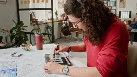 Busy Male UI Developer Choosing Wireframe Designs on Tablet Stock Footage 327904568