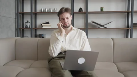 Busy Man Office Worker Manager Consulting Client by Telephone Checking on Laptop 스톡 동영상 301247410