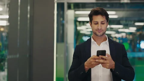 Busy Man Roaming Around the Office and Texting, Resolving Matters Remotely Using Stock-Footage 304175331