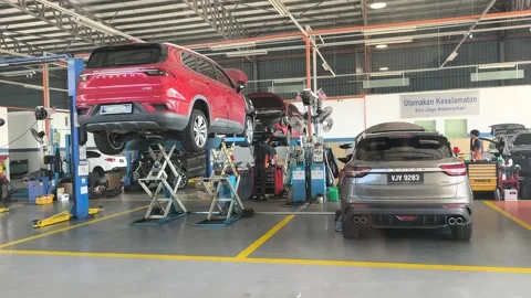 Busy Mechanics Working in Fully Equipped Auto Service Center Stock Footage 336645745