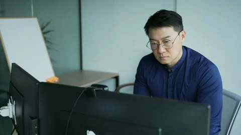 Busy middle aged IT specialist programmer with glasses analyzes working typing  Stock Footage 225738866