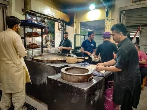 A busy Middle Eastern restaurant kitchen scene with chefs preparing traditi.. Stock Photos