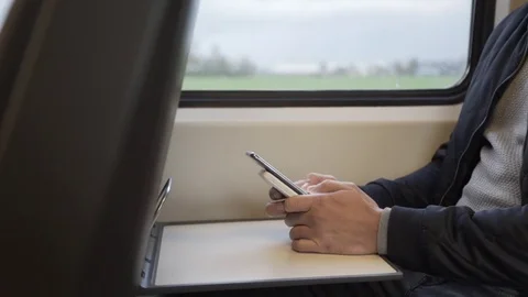 Busy on mobile phone in the train Stock Footage 85224444