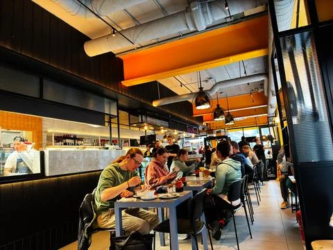 Busy modern cafe restaurant dining with people and friends sharing lunch in.. 写真素材