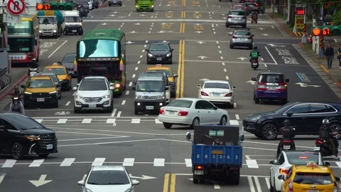 A busy, multi-lane urban intersection in Taipei city, with cars, taxis, buses Stock Footage 329013275
