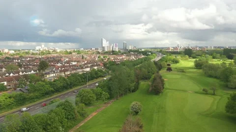 Busy multilane highway leading between residential neighbourhood and golf course Stock Footage 156709565