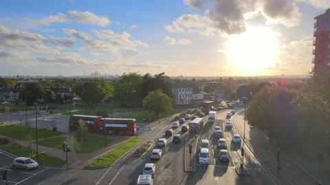 Busy multilane road and surrounding buildings against sun Stock-Footage 164810766