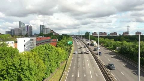 Busy multilane road heading to town, continuous stream of cars Video stock 156699197