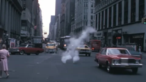 Busy New York Street Corner in 1970s with Cars and Yellow Taxies Stock Footage 254057435