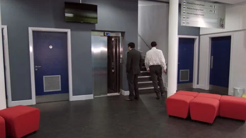 Busy Office Building Lobby With Elevators And Stairs. Businessmen walking Stock Footage 188180009