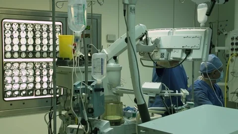 Busy operation room equipment during surgery conducted by doctors Stock Footage 123719832
