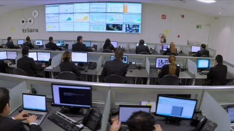 Busy operations center with employees working at computer stations and Stock Footage 344335774