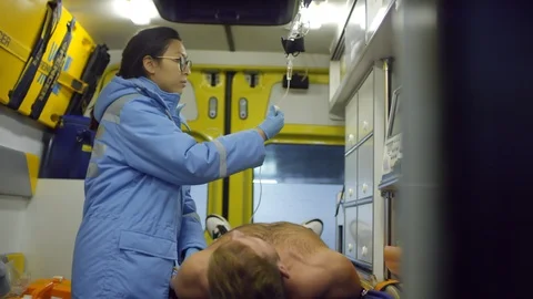 Busy Paramedic Looking at Camera in Ambulance 스톡 동영상 123692133