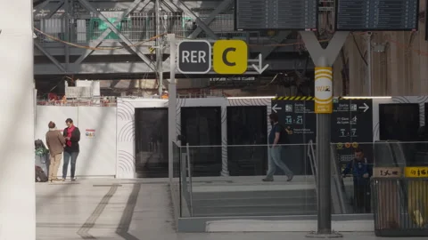 Busy Paris Austerlitz station during renovation, with RER C sign and passengers Stock Footage 306574474