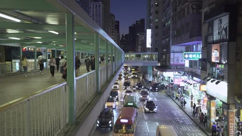 Busy pedestrian overpass over Mong Kok road. Hong Kong at night. Gimbal shot. Stock Footage 103675405